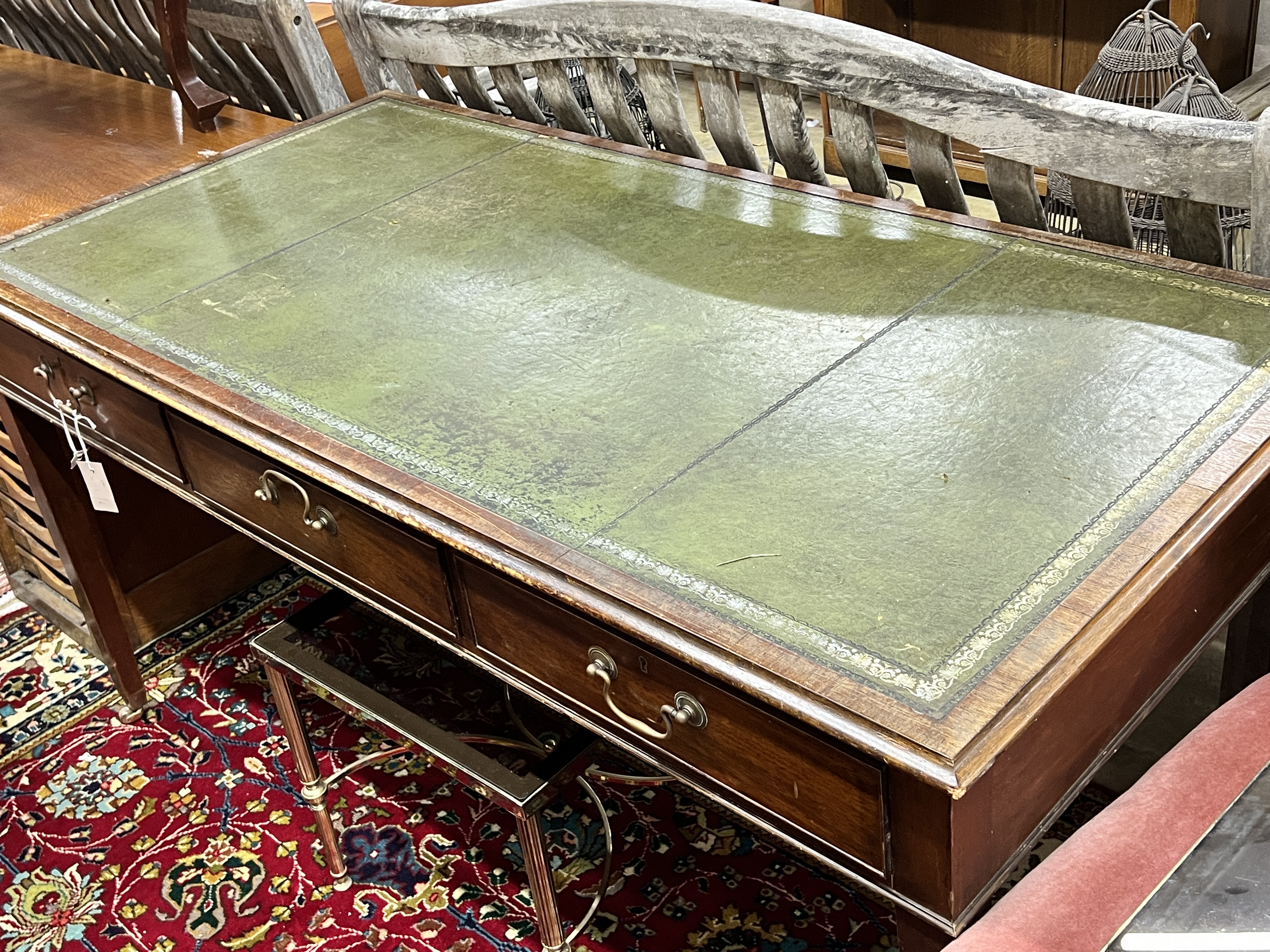 A reproduction George III style mahogany three drawer writing table, width 151cm, depth 74cm, height 76cm